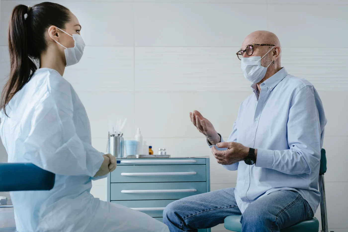 Senior adult patient discussing vaccination with a GP in clinic