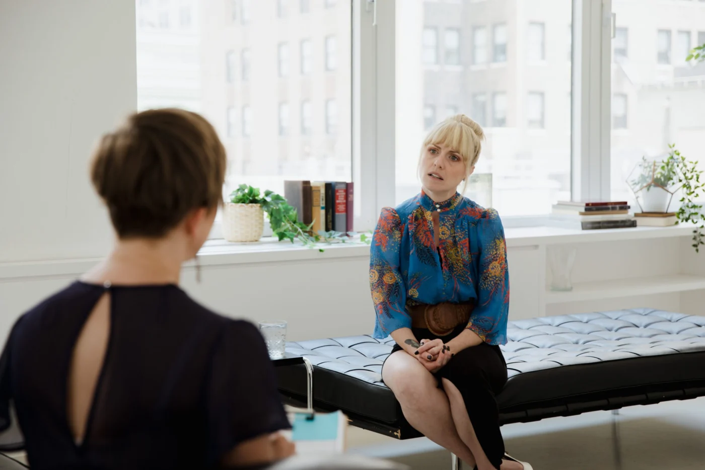Patient in a therapy session with a counsellor in a bright office