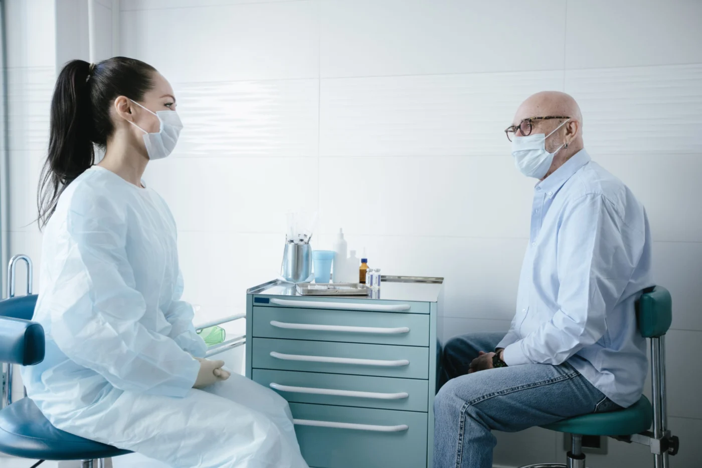 GP consulting with a senior patient about their vaccination schedule