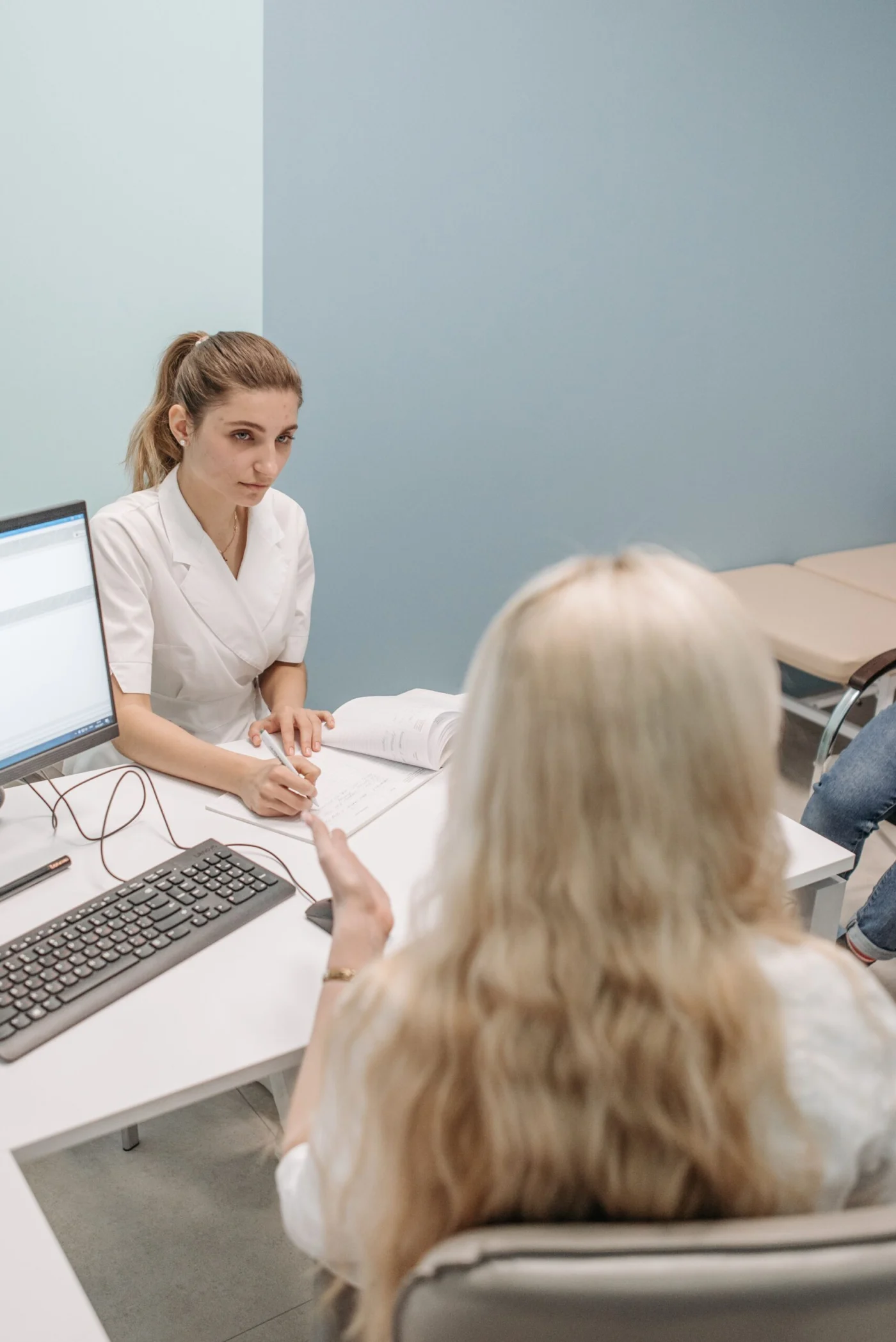 Doctor consulting with a patient about a skin check in a clinic office