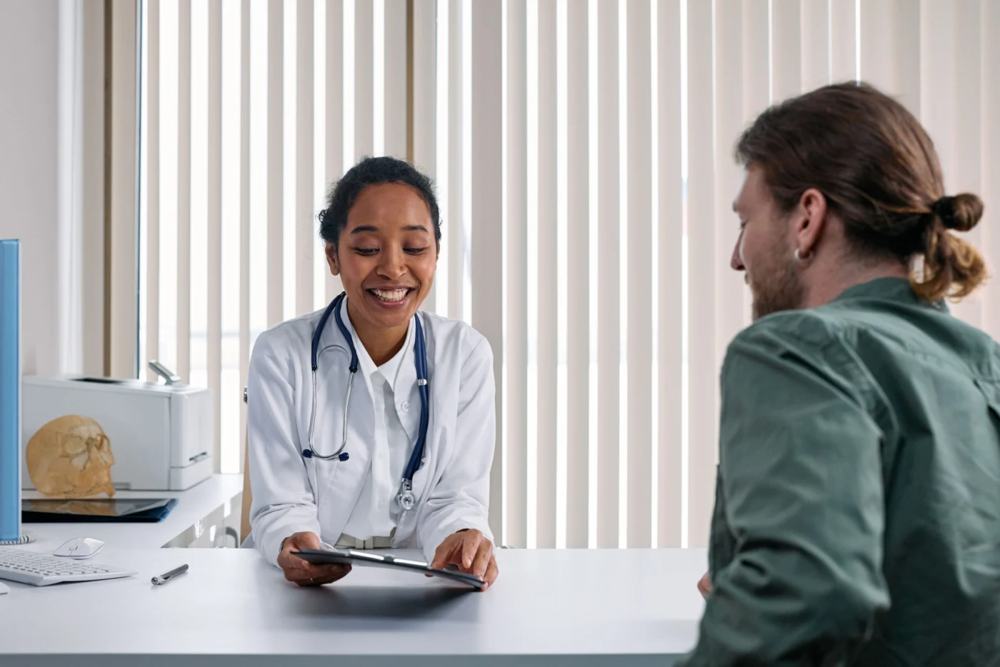 Doctor and patient having a warm, reassuring conversation in a bright clinic setting