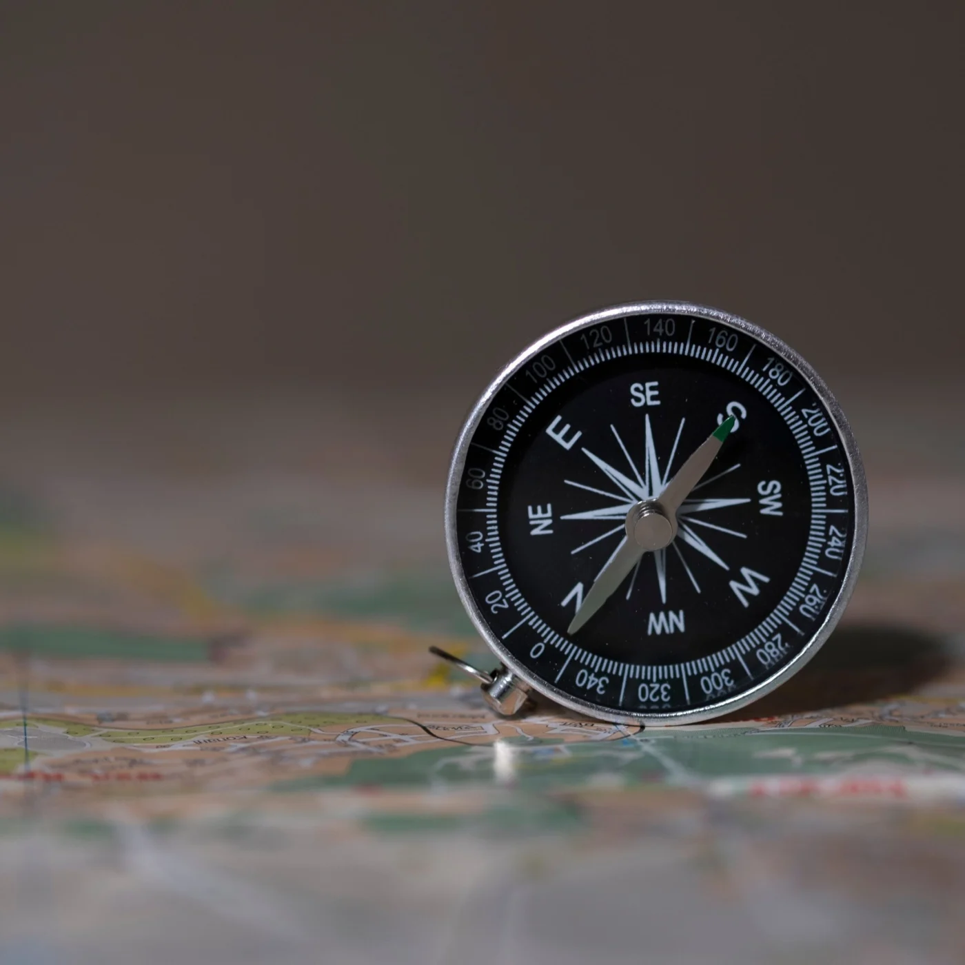 Compass resting on a travel map, symbolising pre-trip route planning before international travel