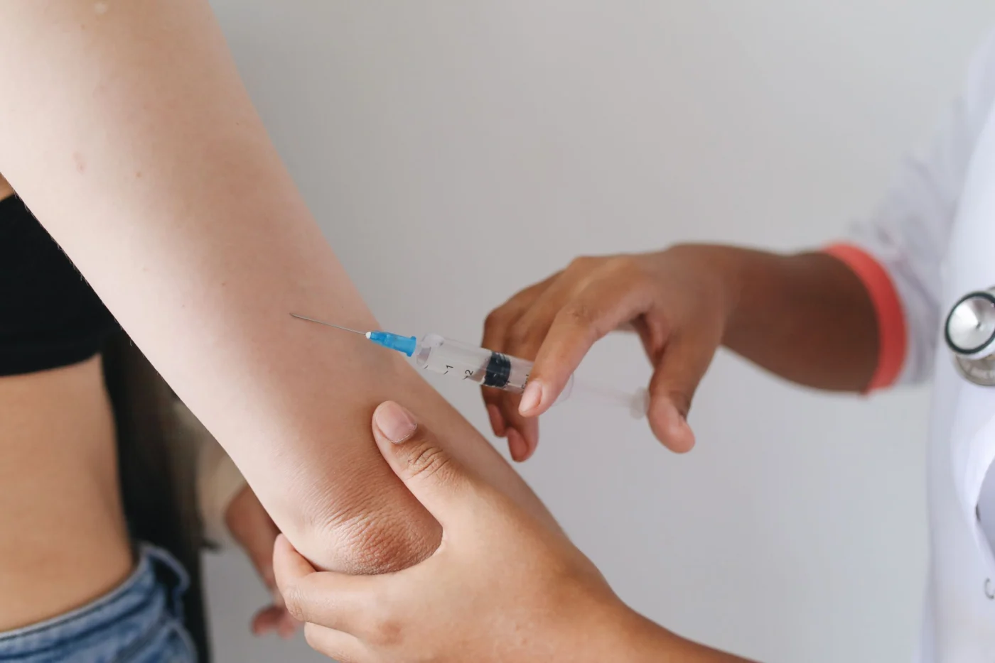 Healthcare provider administering a vaccine injection into a patient's upper arm