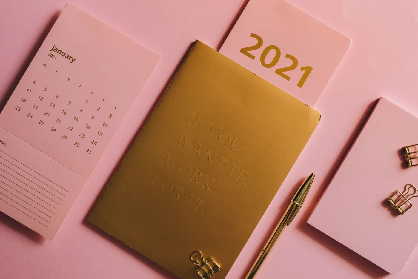 Desk calendar and planner flat lay, symbolising scheduling a follow-up vaccine dose