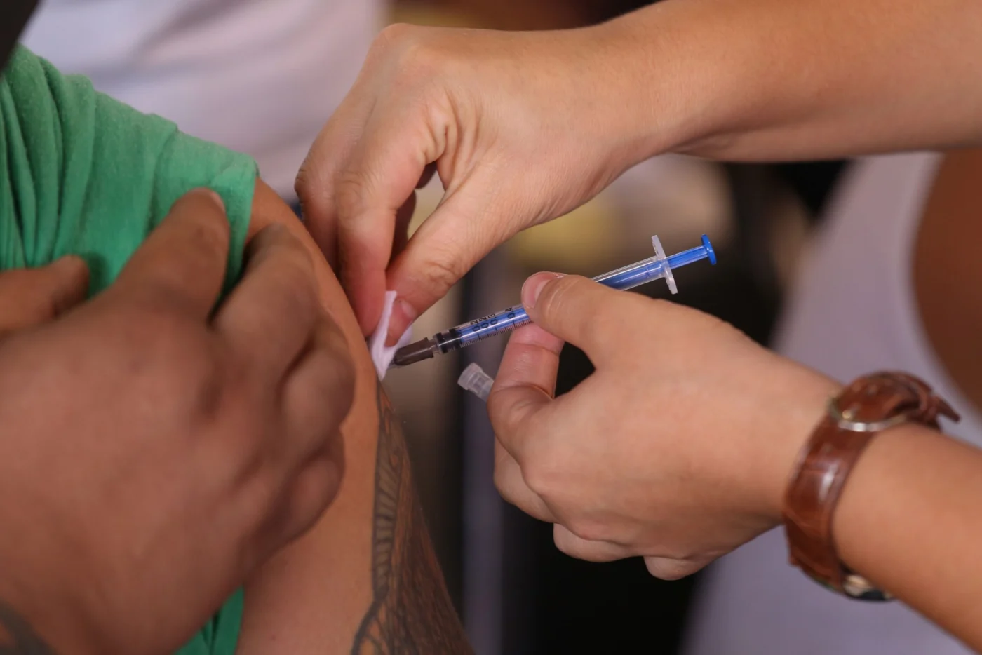 Healthcare worker administering a vaccine injection into a patient's arm